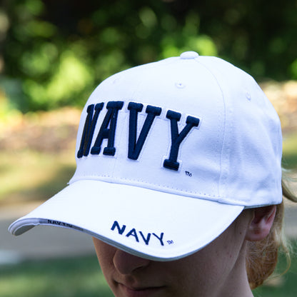 Navy Hat 3-D - white cap with navy colored raised NAVY letters on the front and navy colored embroidered NAVY letters on the side of the brim