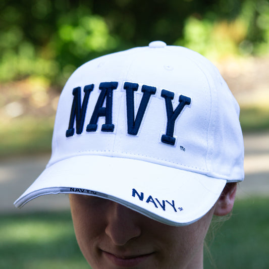 Navy Hat 3-D - white cap with navy colored raised NAVY letters on the front and navy colored embroidered NAVY letters on the side of the brim