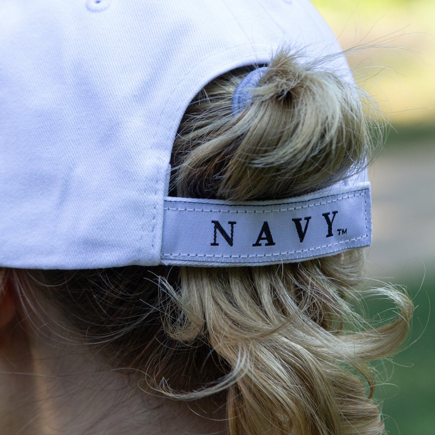 Navy Hat 3-D - white cap with navy colored raised NAVY letters on the front and navy colored embroidered NAVY letters on the side of the brim