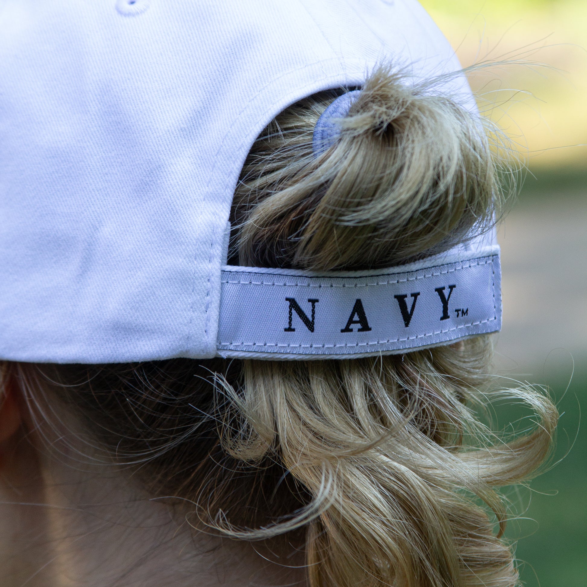 Navy Hat 3-D - white cap with navy colored raised NAVY letters on the front and navy colored embroidered NAVY letters on the side of the brim